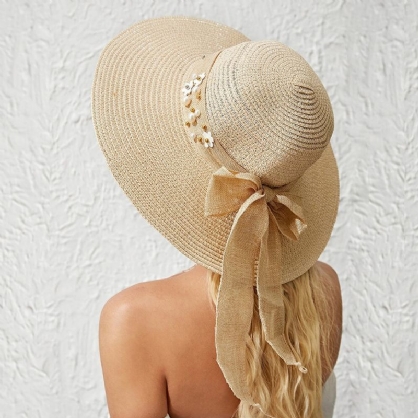 Mujeres Paja Color Sólido Elegante Ala Grande Perla Bowknot Borde Ondulado Visera Sombrero Para El Sol Sombrero De Playa Sombrero De Cubo