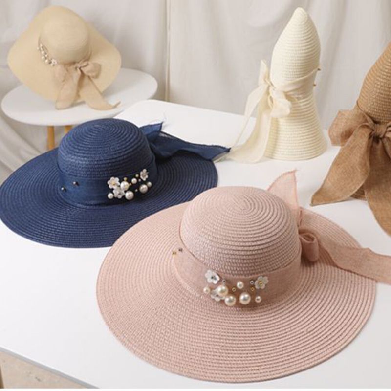 Mujeres Paja Color Sólido Elegante Ala Grande Perla Bowknot Borde Ondulado Visera Sombrero Para El Sol Sombrero De Playa Sombrero De Cubo